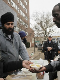 Sikh Community Center volunteers serving hot meals in the Far Rockaways, via AP. (source: Gawker)
