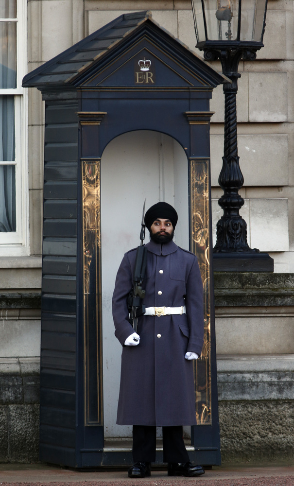 Jatinderpal Singh Bhullar, 25, a Sikh soldier with the Scots Guards, performs guarding duties outside Buckingham Palace in central London, Tuesday, Dec. 11, 2012. becoming the first guardsman to parade wearing a turban instead of the famous bearskin. (source: Huffington Post)