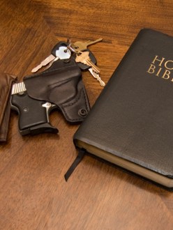 A Bible, gun, keys and wallet on top of a table. (source: FMG Law)