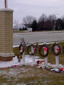 Sign for the Sikh Temple of Wisconsin in Oak Creek, alongside memorials for the six victims of the mass shooting in August. (source: Al Jazeera)