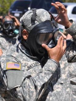 Tejdeep Singh Rattan dons a gas mask during his military training in 2010. (source: US Army)