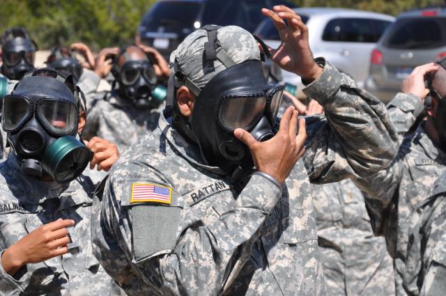 Tejdeep Singh Rattan dons a gas mask during his military training in 2010. (source: US Army)