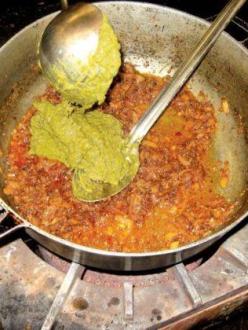 "Chef Partap Singh adds cooked and pureed mustard greens to a sauteed base of garlic, ginger, onion, salt, pepper and chili as he prepares saag, a vegetarian curry, in the kitchen of the Tierra Buena Sikh Temple." (photo: Laura van der Meer/Appeal-Democrat)