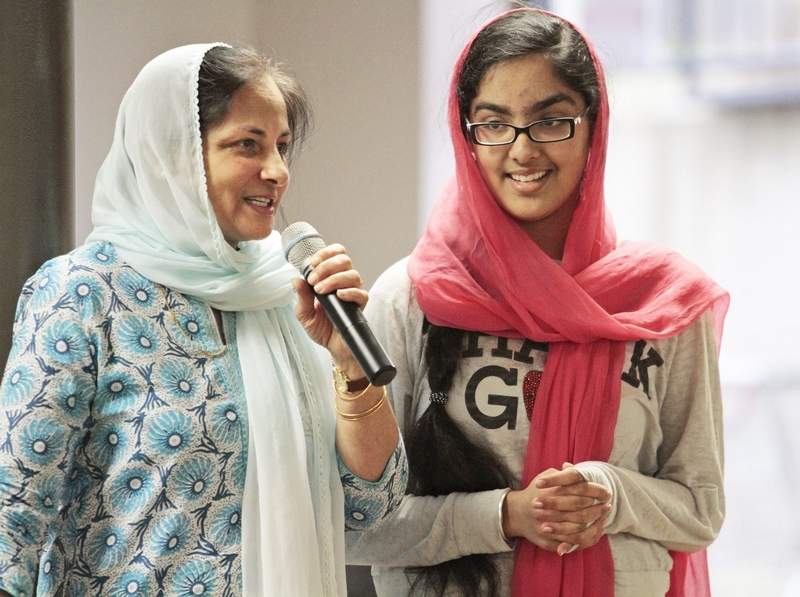 "Dr. Harminder Kaur and her daughter, Hana Mangat, 13, of Potomac, talk with children at the Guru Gobind Singh Foundation Sikh temple about a movie they made to educate people about Sikhism. The first viewing of the film was held Sunday in Rockville." (credit: Bill Ryan/Maryland Gazette)