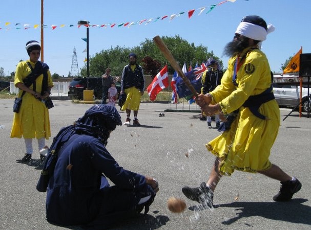 "A blindfolded martial arts master splits a coconut on the head of his colleague without touching his head, an action so fast he had the club raised again before the coconut fell." (source: Jessica Skropanic | Record Searchlight)