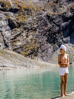 "A Sikh boy stands on the water’s edge [at Hemkund Sahib]. It’s estimated that upward of 150,000 people make it to Hemkund each year." (Photo credit: Michael Benanav | The New York Times)