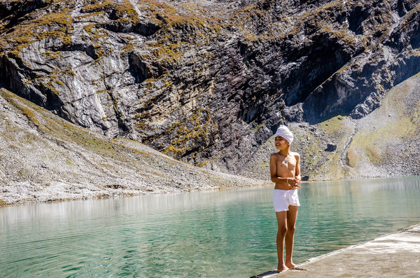 "A Sikh boy stands on the water’s edge [at Hemkund Sahib]. It’s estimated that upward of 150,000 people make it to Hemkund each year." (Photo credit: Michael Benanav | The New York Times)