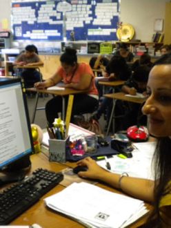 "Simran Kaur, advocacy manager for the Sikh Coalition, recently spoke to 10 classes at Selma High School to help educate them about the Sikh community. The coalition wants to increase awareness, following the May 5 beating of an 82-year-old Sikh man in Fresno. The Fresno County District Attorney’s Office has called the assault a hate crime. Here, Kaur sits at teacher Alison Sickler’s desk as students write about what they learned from Kaur’s presentation." (Source: The Selma Enterprise)