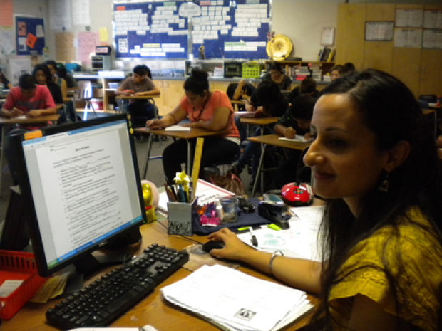 "Simran Kaur, advocacy manager for the Sikh Coalition, recently spoke to 10 classes at Selma High School to help educate them about the Sikh community. The coalition wants to increase awareness, following the May 5 beating of an 82-year-old Sikh man in Fresno. The Fresno County District Attorney’s Office has called the assault a hate crime. Here, Kaur sits at teacher Alison Sickler’s desk as students write about what they learned from Kaur’s presentation." (Source: The Selma Enterprise)