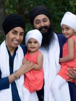 "Ikman and Manjot Singh, shown here with their children, were forced to leave an AMC theater in Emeryville, Calif., after security guards accused the couple of carrying weapons." (Source: India West)