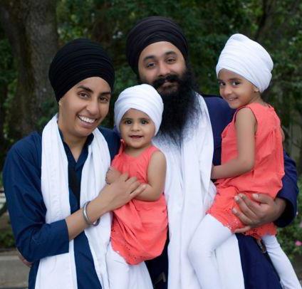 "Ikman and Manjot Singh, shown here with their children, were forced to leave an AMC theater in Emeryville, Calif., after security guards accused the couple of carrying weapons." (Source: India West)
