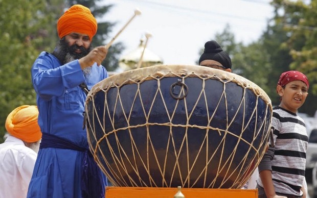 "Jaljit Singh Khalsa, of Beaverton, sets the beat during the procession during annual Sikh celebration honoring Guru Arjan Dev Ji at it leaves the Dasmesh Darbar Sikh Temple, in South Salem [Oregon], on Sunday, June 16, 2013." (Photo: Timothy J. Gonzalez | Statesman Journal) 