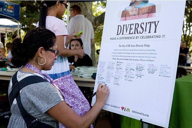 A participant at the 2012 Elk Grove, California, Multicultural Festival signs a "Diversity Pledge." (Source: City of Elk Grove)