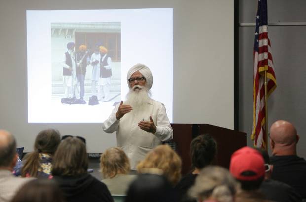 "Santokh Singh Sahi speaks with guest during a meet-greet with members of the Sikh community, on Tuesday, Sept. 10, 2013 at the Glen Avon Library. " (Credit: STAN LIM/Press-Enterprise)