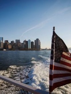 "A woman on the deck of a boat headed to Ellis Island in New York." (Credit: Lucas Jackson/Reuters. Source: New York Times.)