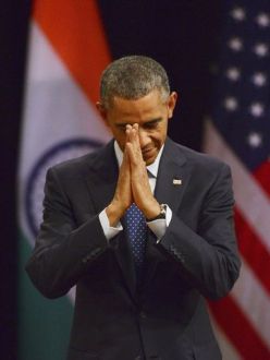 "President Obama delivers a traditional Indian greeting before he speaks on Jan. 27 in New Delhi, India. The president, who was guest of honor at India's Republic Day celebrations, wrapped up his visit by talking about the freedom to practice one's religion, the rights of women and the need to provide every child with equal opportunity." (Photo: European Pressphoto Agency. Source: USA Today.).